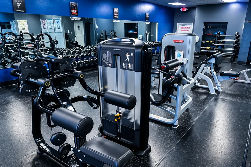 Dumbbell rack and adjustable benches in front of the mirrored wall